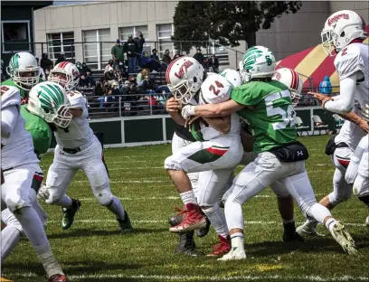  ?? PHOTOS BY JOSE QUEZADA OF HUMEDIA — FOR THE TIMES-STANDARD ?? Eureka High Logger Brandon Racines powers through a pair of St. Bernard’s Crusader defenders for a touchdown.