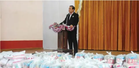  ??  ?? BANGKOK: Thailand’s Prime Minister Prayut Chan-O-Cha addresses government officials and residents at Narathiwat City Hall, in front of stacks of emergency care packages for flood victims, in the southern Thai province of Narathiwat yesterday. —AFP