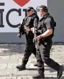  ?? —AP ?? Armed police patrol Manchester City following a suicide bombing that killed more than 20 people at an Ariana Grande concert and sent security officials searching for more antiterror measures that include bans on laptops.