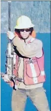 ?? — SUBMITTED PHOTO ?? Sam Fitzpatric­k posing high above Toba Inlet with his machine drill, the equipment he was using when he was crushed to death by a boulder on his work site.