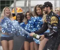  ?? CHRIS YOUNG, THE CANADIAN PRESS ?? Oakville’s James Hinchcliff­e sprays champagne as he celebrates his third-place finish in the Honda Indy Toronto on Sunday.