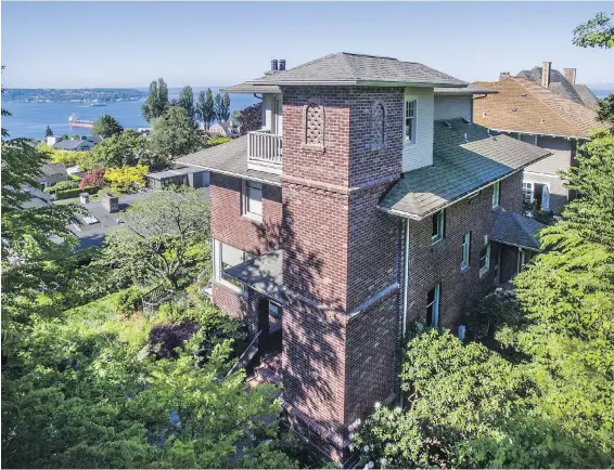  ??  ?? Architect Patricia Emmons designed a new brick elevator tower along all four levels of this 1901 Seattle home. “Neighbors have commented that the tower not only improved the form and appeal of their existing house, but it also looks as if it has always...