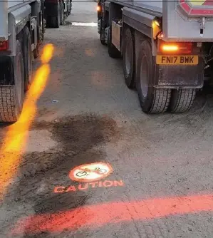  ??  ?? The safety system can be fitted to HGVs and projects a warning sign onto the road to alert cyclists to keep their distance while a manoeuvre is about to take place