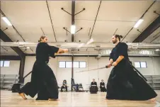  ?? ?? Lead instructor Aaron Garlick, left, and assistant instructor Travis Webb engage in kendo kata during practice Friday (March 18) in Taos.