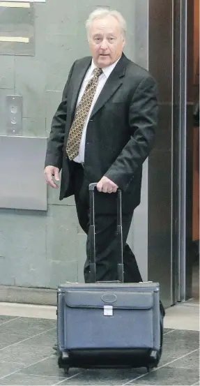  ?? FRANCIS VACHON FOR NATIONAL POST FILES ?? Quebec Superior Court Justice Michel Girouard leaves the courthouse in Quebec City. He is accused of buying illicit drugs in the back office of a video store.