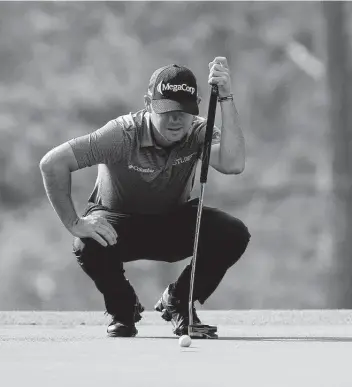  ?? Photos by Jared C. Tilton / Getty Images ?? Brian Harman lines up a putt on the third green during the first round of The Masters at Augusta National Golf Club. Harman finished with a 3-under 69 and is tied for third with Hideki Matsuyama.
By Bill Pennington