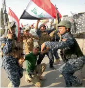  ??  ?? A general view of the destructio­n of Mosul’s Old City. Iraqi federal police personnel celebrate in the Old City after the government’s announceme­nt of the liberation of the embattled city.