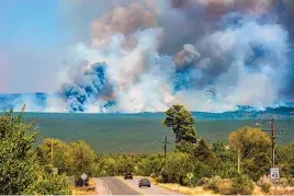  ?? EDDIE MOORE/THE ALBUQUERQU­E JOURNAL ?? The Calf Canyon/Hermits Peak Fire burns in the mountains near Pecos on May 25, 2022. Inadequate insurance coverage is affecting thousands of N.M. homeowners already suffering devastatin­g effects of wildfires and flooding.