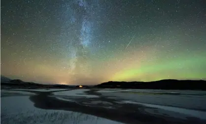  ??  ?? The aurora borealis and Milky Way from inside the Arctic circle in October. The hole is not expected to harm humans unless it extends further south. Photograph: Tommy Eliassen/Science Photo Library