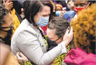  ?? John Minchillo Associated Press ?? COURTENEY ROSS, George Floyd’s girlfriend, left, hugs Katie Wright, Daunte Wright’s mom.