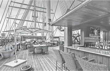  ?? ALLISON GUZY ?? Philadelph­ia bar and lounge The Deck opens every summer above Moshulu, a restaurant on a ship built in 1904. The vessel is docked at Penn’s Landing on the Delaware River waterfront.