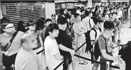  ??  ?? The impact of the Internet and the freedom of thought and views in Singapore have led to a decline in the government vote base. Picture shows people lining up to enter a branch of M1 Limited, a telecommun­ications company in Singapore, to purchase the...