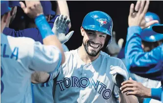  ?? DUANE BURLESON THE ASSOCIATED PRESS ?? Toronto Blue Jays’ Randal Grichuk celebrates with teammates after hitting a two-run home run against the Tigers Sunday afternoon in Detroit. The Blue Jays won, 8-4, snapping a five-game losing streak.