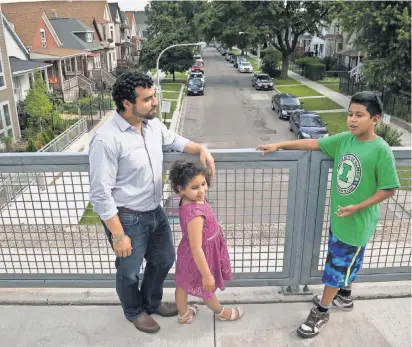  ?? PHOTOS BY TYLER MALLORY, USA TODAY ?? Juan Carlos Linares, shown with his children, Amaru and Maya, is executive director of LUCHA, a Chicago group that backs an ordinance that would make it costly for developers to tear down homes near The 606 trail.