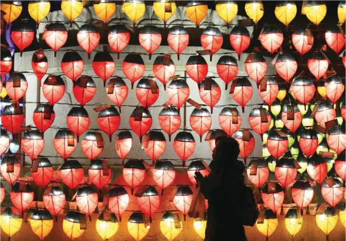  ??  ?? SEOUL: A woman prays in front of lanterns to celebrate the New Year at Chogye Buddhist temple. — AP