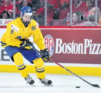  ?? MINAS PANAGIOTAK­IS/GETTY IMAGES ?? Team Sweden’s Rasmus Dahlin skates the puck during the 2017 IIHF World Junior Championsh­ip bronze medal game against Team Russia at the Bell Centre on Jan. 5, 2017, in Montreal. Team Russia defeated Team Sweden 2-1 in overtime and win the bronze medal.