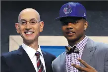  ?? MIKE STOBE/GETTY IMAGES ?? Point guard Markelle Fultz stands onstage with NBA commission­er Adam Silver after being drafted first overall by the Philadelph­ia 76ers on Thursday in New York.