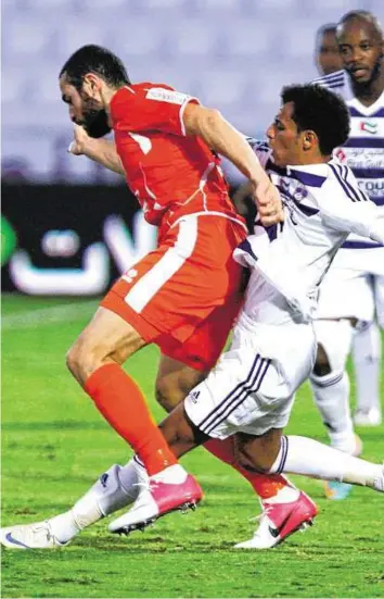  ?? HADRIAN HERNANDEZ/ Gulf News ?? Khaled Abdul Rahman ( right) of Al Ain battles for the ball with Driss Fettouhi of Ajman Club during their Etisalat Pro- League match on Saturday.