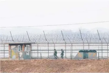  ?? AHN YOUNG-JOON/AP ?? South Korean army soldiers patrol along a fence Wednesday in Paju near the border with North Korea.