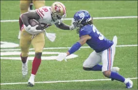  ?? COREY SIPKIN - THE ASSOCIATED PRESS ?? San Francisco 49ers’ Jeff Wilson, left, fends off New York Giants’ Ryan Lewis during the second half of an NFL football game, Sunday, Sept. 27, 2020, in East Rutherford, N.J.