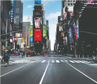  ?? SPENCER PLATT / GETTY IMAGES ?? Times Square in New York City stands mostly empty on Sunday as much of the city is void of cars and pedestrian­s. “This is going to be the greatest crisis domestical­ly since the Great Depression,” says Bill de Blasio, the city’s mayor.