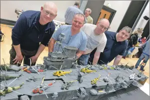  ??  ?? Right: The largest model in the show, the Ark Royal aircraft carrier with modellers Douglas Barr, Robert Wilson, Martin Kane and David MacEachan. Photograph: Iain Ferguson, The Write Image