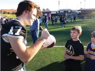  ?? Staff photo by Junius Stone ?? ■ Riley Durmon, senior and cornerback, enjoys Saturday’s salute to the Hawks along with Jakyla Jackson, freshman student, whose brother, Elija Jackson, senior, was part of the champion team that brought home the victory.