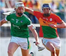  ??  ?? SURGE: Limerick’s Cian Lynch tries to escape the attention of Carlow’s Diarmuid Byrne at Netwatch Cullen Park