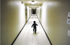  ?? GREGORY BULL AP FILE ?? An asylum-seeking Central American boy runs down a hallway at a San Diego shelter in 2018.