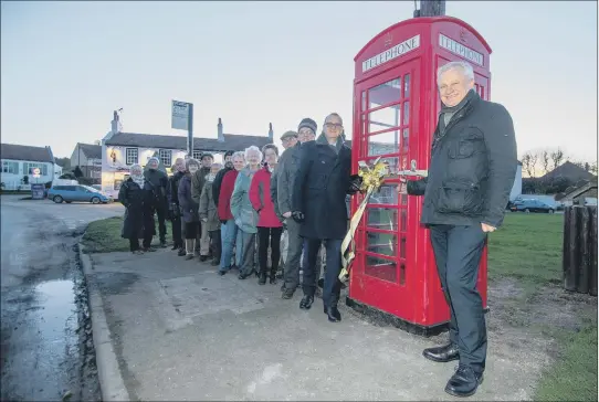  ?? PICTURE: JAMES HARDISTY. ?? RINGING ENDORSEMEN­T: Graham Stuart, MP for Beverley and Holderness, right, with villagers at the reopening of the red telephone box in Atwick, near Hornsea.