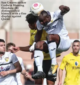  ??  ?? San Gwann striker Godwin Blessing Henshaw (R) distinguis­hed himself with a fine display against Qormi