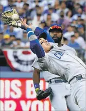  ?? Wally Skalij Los Angeles Times ?? THE CUBS’ Javier Baez extends to make a catch on a ball off the bat of the Dodgers’ Austin Barnes.