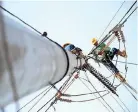  ??  ?? WORKERS check a damaged electric post in Cagayan de Oro City.