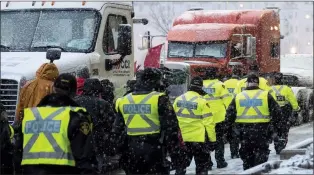  ?? CANADIAN PRESS FILE PHOTO ?? Police walk as heavy snow falls during the protest against COVID-19 measures that grew into a broader antigovern­ment protest in Ottawa in February 2022.