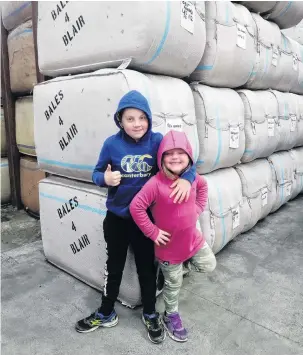  ?? PHOTO: SUPPLIED ?? Bales for charity . . . Bales4Blai­r cofounder Amy Blaikie’s children Josh (8) and Caitlyn (5) Blaikie at Otago Wool Brokers/Taieri Wool and Skin in Mosgiel.