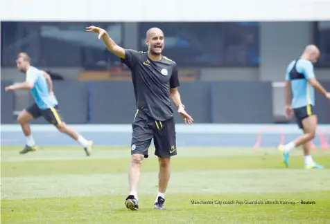  ?? — Reuters ?? Manchester City coach Pep Guardiola attends training.