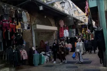  ?? LEO CORREA — THE ASSOCIATED PRESS FILE ?? File - Muslim women walk through a market, ahead of the holy Islamic month of Ramadan, in the Old City of Jerusalem, Thursday, March 7, 2024. Restrictio­ns put in place amid the Israel-hamas war have left many Palestinia­ns concerned they might not be able to pray at Al-aqsa Mosque compound, which is revered by Muslims.