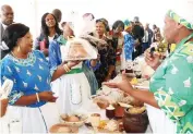  ?? - Pictures: John Manzongo ?? First Lady Dr Auxillia Mnangagwa looks at one of the cakes made from traditiona­l ingredient­s during Amai’s traditiona­l cookout competitio­n finals in Mashonalan­d West province yesterday.