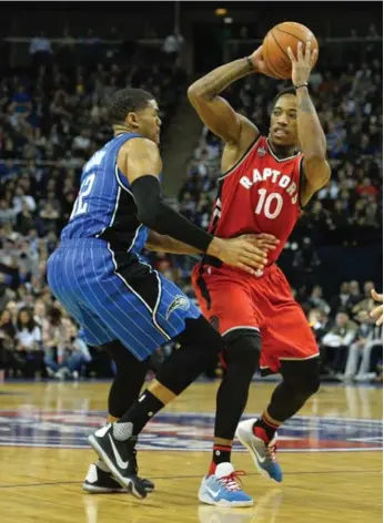  ?? GLYN KIRK/AFP/GETTY IMAGES ?? Raptors’ DeMar DeRozan looks for some help past the defence or Orlando’s Tobias Harris during play in London.