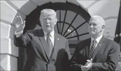  ?? AP PHOTO ?? President Donald Trump, left, with Vice President Mike Pence, waves after speaking about the economy from the South Lawn of the White House, Friday in Washington.