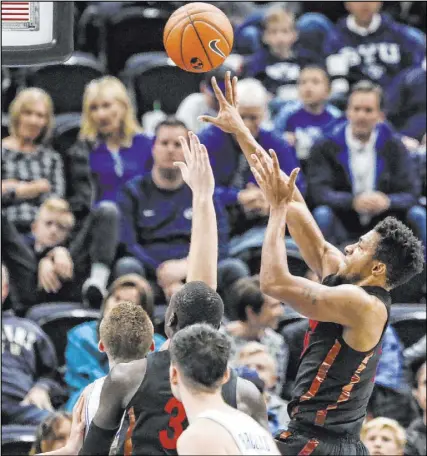  ?? Colter Peterson The Associated Press ?? UNLV forward Nick Blair tries a short jumper in the second half of the Rebels’ 83-50 blowout by Brigham Young on Saturday in Salt Lake City. Blair finished with 10 points and seven rebounds.