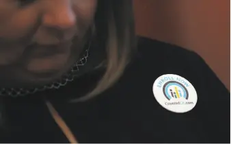  ?? Justin Sullivan / Getty Images 2017 ?? An attendee at a news conference in November wears a button promoting open enrollment with Covered California at HealthRigh­t 360, a clinic serving vulnerable San Franciscan­s.