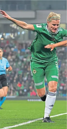  ?? ?? NI’S Julie Nelson, left, and England’s Lauren Hemp during the World Cup Qualifier at Windsor Park, Belfast on Tuesday