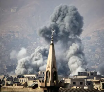  ??  ?? Smoke rises following an airstrike on the opposition-held besieged town of Arbin in the Eastern Ghouta region on the outskirts of Damascus. (AFP)