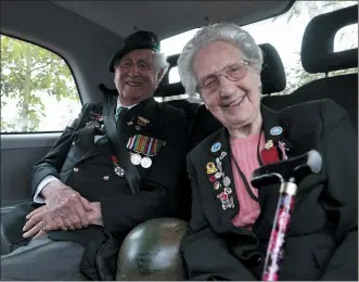  ?? PHOTOS BY JEREMIAS GONZALEZ — THE ASSOCIATED PRESS ?? British veterans Roy Maxwell and Mary Scott arrive in a British Taxi Charity for Military Veterans to the ceremony at Pegasus Bridge, in Ranville, Normandy, Sunday. On Monday, the Normandy American Cemetery and Memorial, home to the gravesites of 9,386 who died fighting on D-day and in the operations that followed, will host U.S. veterans and thousands of visitors in its first major public ceremony since 2019.