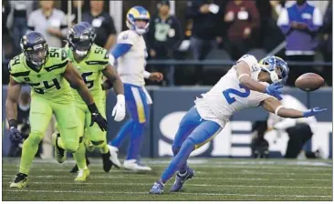  ?? Craig Mitchelldy­er Associated Press ?? RAMS receiver Robert Woods (2) contorts his body to haul in a pass from quarterbac­k Matthew Stafford.