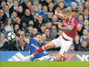  ?? Picture: REUTERS ?? BIG BLOW: Middlesbro­ugh’s Adam Clayton, right, tackled by Chelsea midfielder Cesc Fabregas during their Premier League clash. Middlesbro­ugh were relegated after losing 3-0