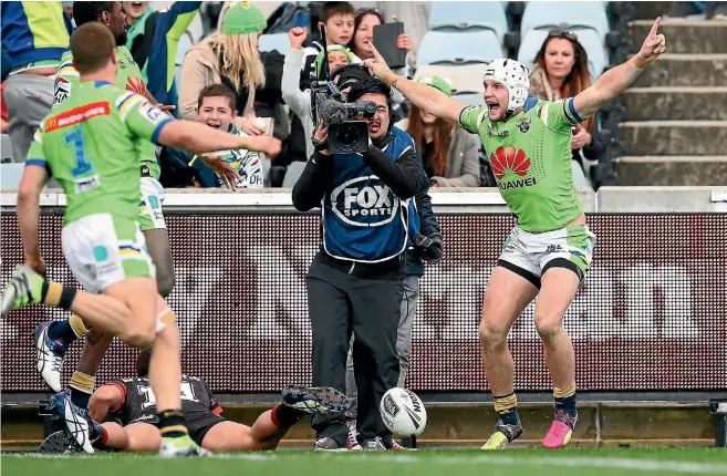  ?? PHOTO: GETTY IMAGES ?? Jarrod Croker of the Raiders, right, celebrates his try that gave his team victory over the Warriors in golden point in an NRL match in Canberra on Saturday.