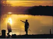  ?? Wally Skalij Los Angeles Times ?? TWO MEN fish from a dock on the Sacramento­San Joaquin River Delta in Stockton.