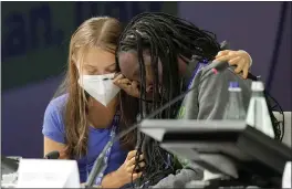  ?? LUCA BRUNO — THE ASSOCIATED PRESS ?? Ugandan climate activist Vanessa Nakate, right, is comforted by Swedish activist Greta Thunberg as she is overcome by emotion after speaking at the opening of a threeday Youth for Climate summit in Milan, Italy, on Tuesday.